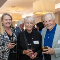 Tom and Joyce Beck posing for photo with another event attendee